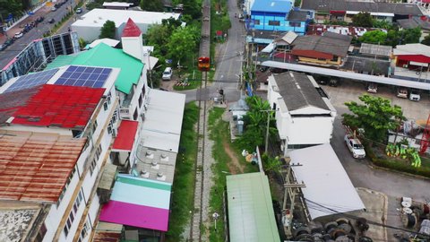 Aerial view of Rom Hoop market. Thai Railway with a local train run through Mae Klong Market in Samut Songkhram Province, Thailand. Tourist attraction in travel and transportation concept.