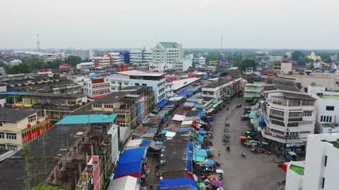 Aerial view of Rom Hoop market. Thai Railway with a local train run through Mae Klong Market in Samut Songkhram Province, Thailand. Tourist attraction in travel and transportation concept.