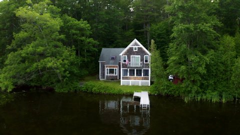 DRONE - Vacation house cabin on a lake in New England with a pond and blue water dock