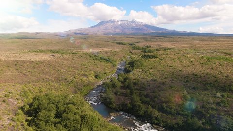 Aerial of Mount Tongariro and alpine stream with fresh water from the melting snow. Mt Tongariro National Park. North Island. New Zealand