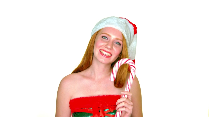santa claus girl holding candy cane smiling