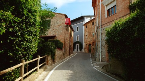 Walking along picturesque houses in the medieval town Lajatico, Tuscany, Italy, the home town of tenor Andrea Bocelli