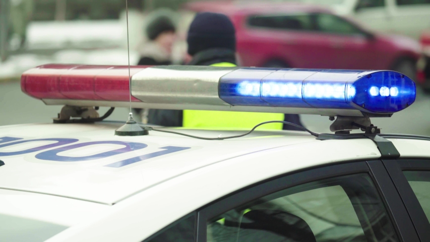 Flashing flasher on the roof of a police car. Blinker. Close-up.