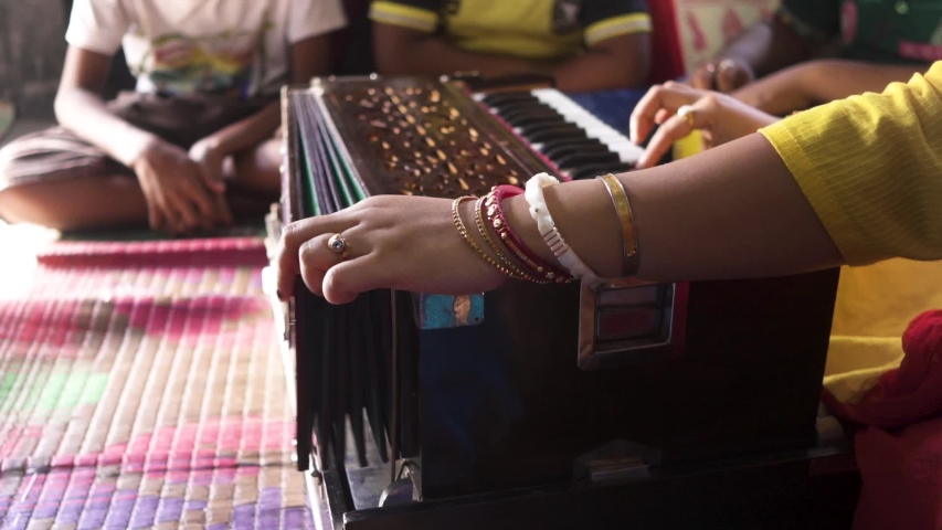 Married Indian teacher playing music with harmonium at classroom, students learning music, unrecognizable Royalty-Free Stock Footage #1042417414