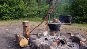 The video of burns and the food is cooked in pots in nature