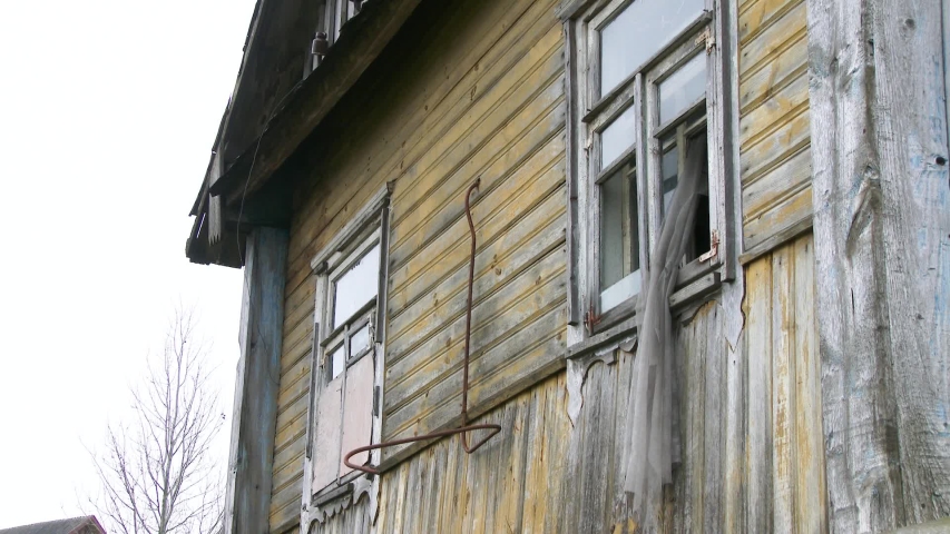An old abandoned house with broken Windows. Abandoned house in the exclusion zone in Chernobyl, the city of Pripyat.