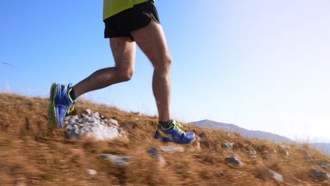 Marathon runner's legs running through the wasteland in slow motion