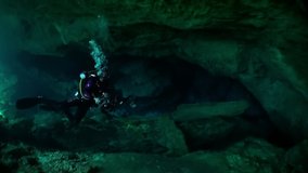 View from under clear water to trees and tree roots and ray of suns in cave of underwater Yucatan Mexico cenotes. Cave diving. Unique beautiful video footage of wildlife in underwater world.