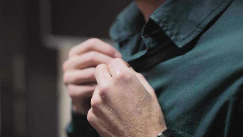 Slow motion young male hands getting dressed at morning buttons cuffs on a shirt preparing for work business clothing formal boss gentleman businessman fashion elegance comfortable fabric close up