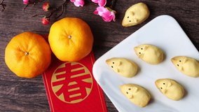 Chinese New Year pineapple cookies made into shape of mouse for the year of mouse celebration. Clip showing hand removing delicious cookies one by one. Lunar New Year decoration and festive goodies
