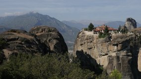 Holy Trinity monastery with tourists walking up the Meteora rock 4K video