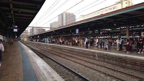 Sydney NSW Australia - Nov 29 2019: Australian People waiting for train at Central Station platform as trains arrive and depart at platform 17. door open for passenger to board and alight