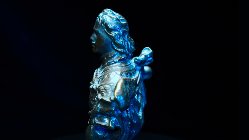Bronze bust of the Peter 1, nicknamed the Great - the last king of all Russia rotates on a black background. Macro. Closeup