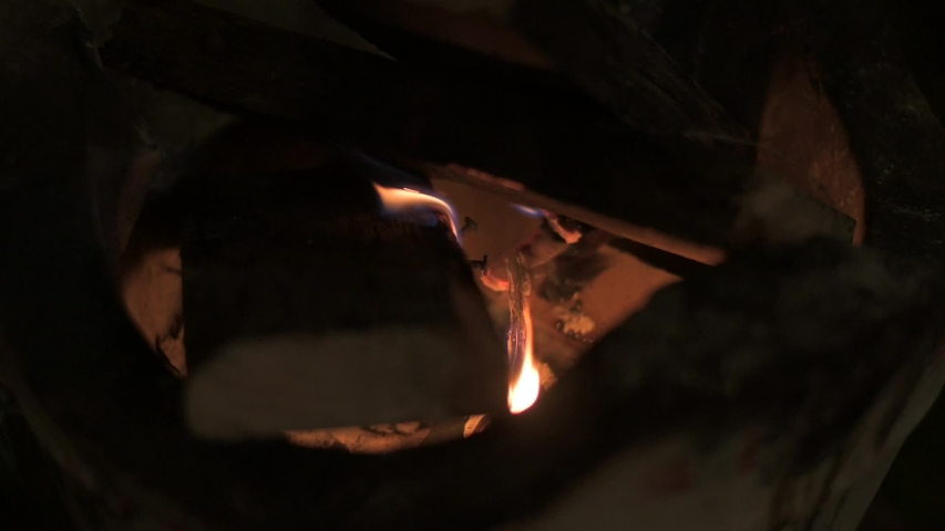 Red hot fire charcoal with burning tree leaves and wooden log on in Thai vintage clay stove | Shutterstock HD Video #1042476520