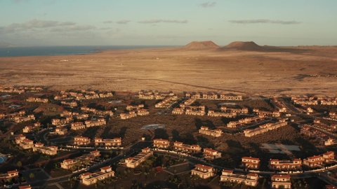 Affluent African town aerial with desert and mountain background