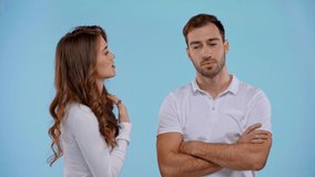 girlfriend talking with loudspeaker to boyfriend isolated on blue