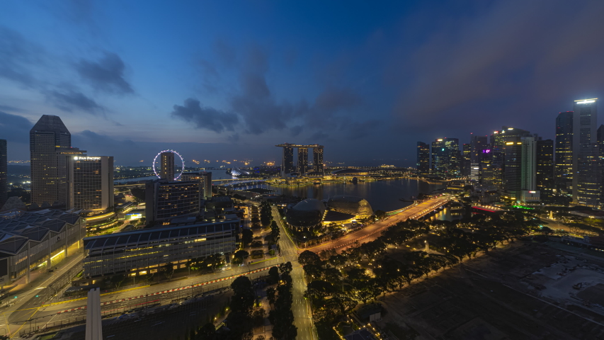 Singapore Beautiful Time lapse of Night to day of Singapore city skyline from aerial and high angle overlooking Marina bay and CBD area. Prores 4K Royalty-Free Stock Footage #1042483735
