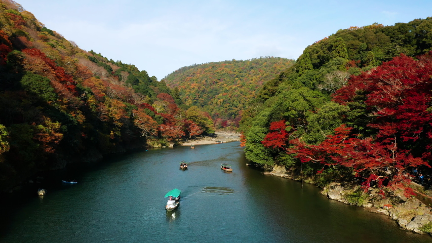 Aerial view of Katsura river at autumn and boats. Arashiyama, Kyoto, Japan Royalty-Free Stock Footage #1042484152