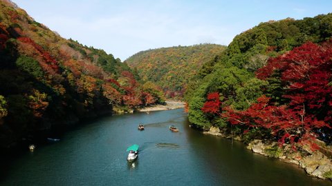 Aerial view of Katsura river at autumn and boats. Arashiyama, Kyoto, Japan