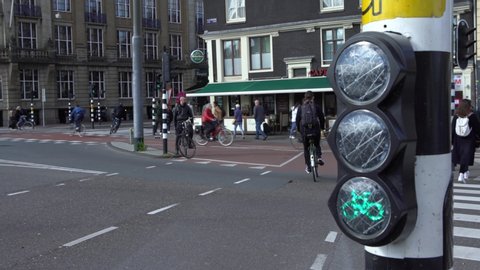 Amsterdam, Netherlands-13 May, 2019: 4K, Bicycle traffic lights change colors at intersection street. Traveling with bikes concept background. Cyclists in traffic. Rules of the road for a bicycle.-Dan