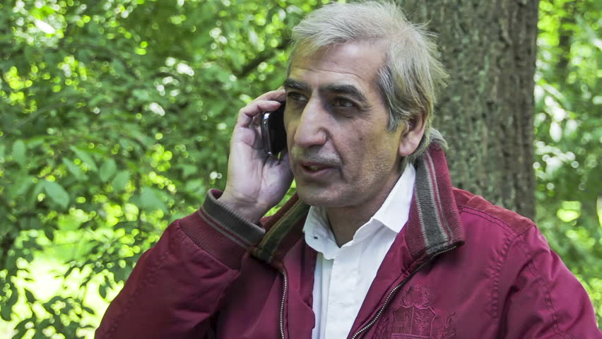 Man speaks on mobile on the beautiful nature