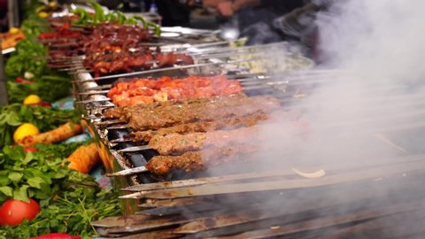 Turkish Adana kebab, ciger kebab on fire with smoke