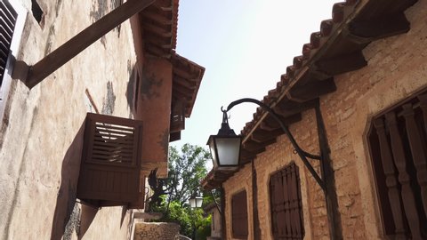 Street of the old city of artists Altos de Chavon. Dominican Republic historical value. UNESCO cultural heritage. Beautiful old city street. Beautiful roofs, lights and window shutters