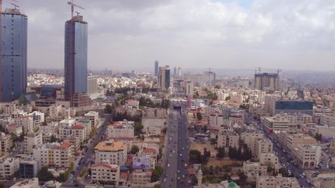 AMMAN, JORDAN - CIRCA 2019 - rising aerial over the city of Amman, Jordan with streets and traffic.