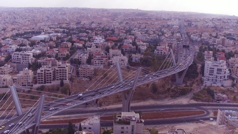 AMMAN, JORDAN - CIRCA 2019 - high aerial over the city of Amman, Jordan and Abdoun Bridge with vehicle traffic.