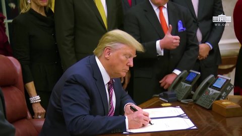 CIRCA 2019 - President Trump signs a bill for the Preventing Animal Cruelty and Torture Act at the White House using a Sharpie in Oval Office.