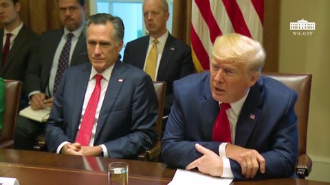 CIRCA 2019 - U.S. President Donald Trump and Senator Mitt Romney sit beside each other at a meeting at the White House.
