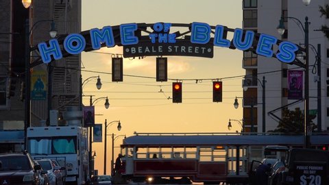 MEMPHIS, TENNESSEE - CIRCA 2010s - Beautiful establishing shot of Beale Street sign, Memphis, Tennessee with trolleys passing.