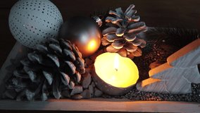 Modern grey and white Advent Christmas time table decoration with warm candle light burning, 4k video footage still