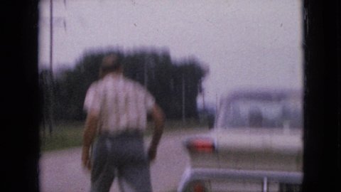 IOWA USA-1967: Man Walking Around Car Hip Thrusting