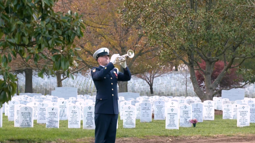 WASHINGTON D.C. - CIRCA 2010s - a patriotic military funeral in Arlington Cemetery, Washington D.C., includes the playing of taps.