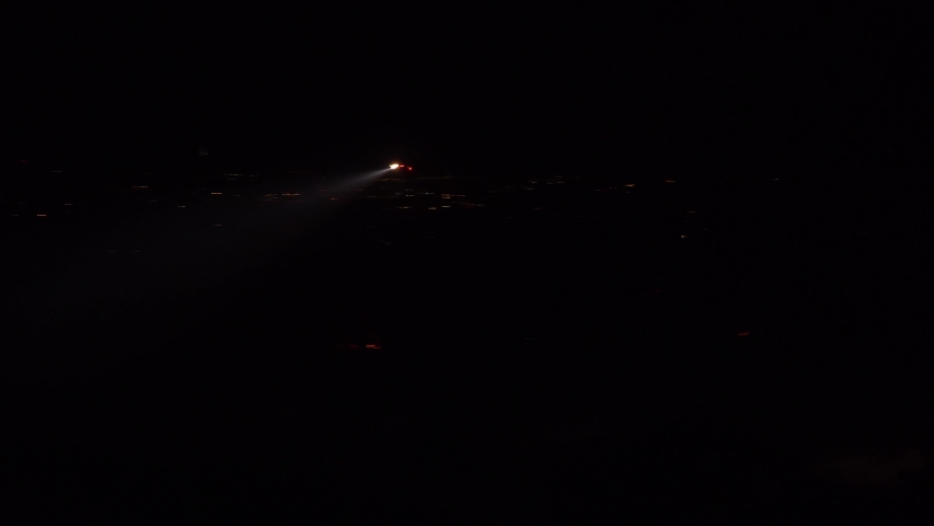 SANTA BARBARA, CALIFORNIA - CIRCA 2010s - a helicopter with a searchlight light flies in the hills above Southern California.