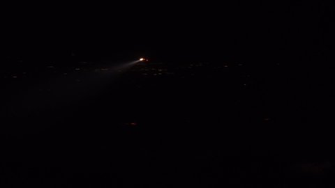 SANTA BARBARA, CALIFORNIA - CIRCA 2010s - a helicopter with a searchlight light flies in the hills above Southern California.