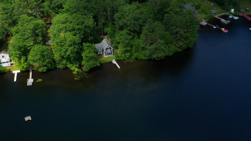 DRONE - Vacation house cabin on a lake in New England with a pond and blue water dock