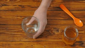 Sporty girl pours almond milk into a glass in the kitchen, slow morion video