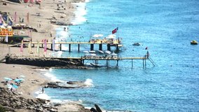 Beautiful beaches in Alanya Turkey with boardwalk / piers and sun-beds for tourists. There are water-sport centres.