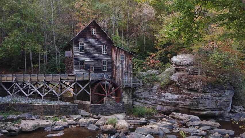 Historic Glade Creek Grist Mill with fall colors on the landscape. Beautiful autumn mountain landscape scenery in the Appalachian Mountains of West Virginia.  
