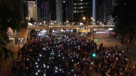 0.8 million peaceful protesters, Holding lighted phones, Human Rights Day Rally, Chanting 'Good man do not join the police, being a police is bastard.' next to Police HQ, Hong Kong- 8 Dec 2019, 7:19pm