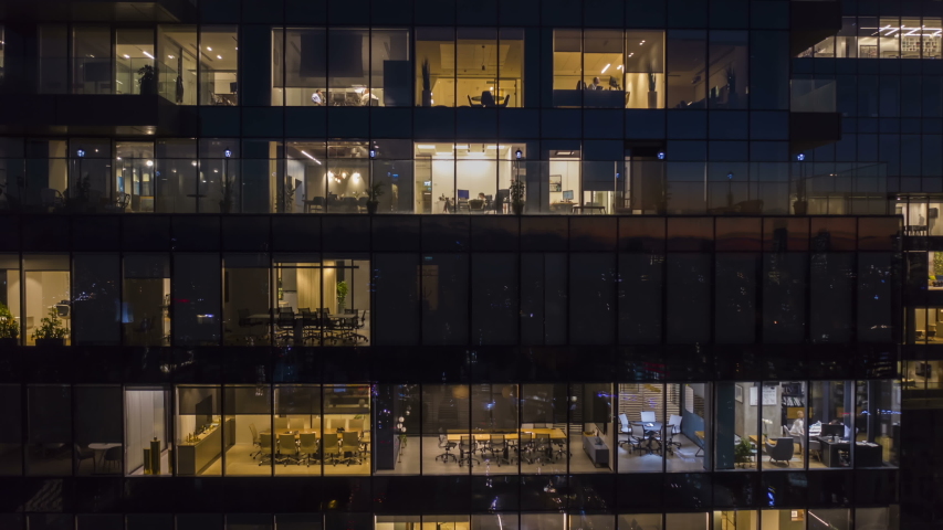 [Hyper Lapse] Workers at office building at night, view trough a window, 4k aerial drone timelapse  | Shutterstock HD Video #1042531453