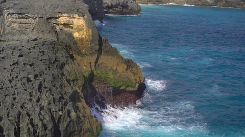 waves are breaking on the rocks at the Angel's Billabong beach at the Nusa Penida island, Indonesia. Slowmotion shot