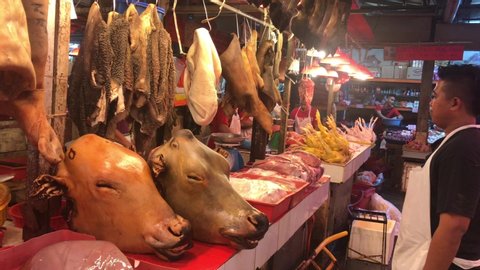 Kuala Lumpur, Malaysia - December 2nd, 2019 :  A Muslim vendor selling a halal fresh chicken and beef meat at a stall in the wet market  . Clip contains noise.
