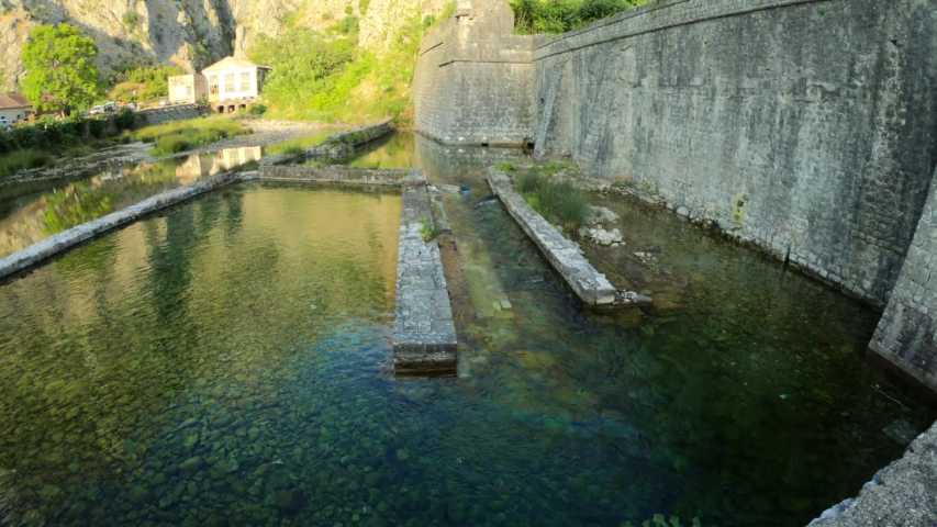 Fisheye lens shot of medieval Kotor city fortress walls from ground to mountain in Montenegro. Castle, popular tourist excursion. Venetian Fortifications