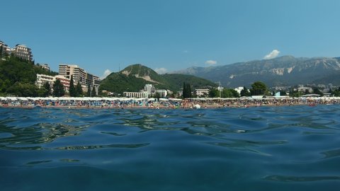 Timelapse View of coast line vacation of Becici town near Budva. Resort beach. Montenegro, Blue sea. Hotels and mountains in the background