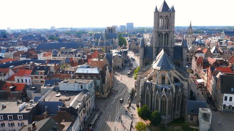 Ghent, Belgium,circa August 2019. Aerial panorama of The Saint Nicholas Church and Gent cityscape from the Belfry of Ghent on a sunny day. Important building in Romanesque and Scheldt Gothic style