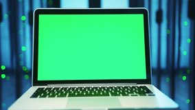 Mock-up chroma key laptop with green screen isolated inside server room. Close-up notebook control device in futuristic high tech database of cyber security. - Powered by Shutterstock - Get 15% off with code: PIKWIZARD15