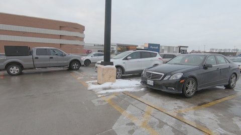 Markham, Ontario, Canada December 2019 Driving plate POV busy shopping mall parking lot full of cars near Toronto
